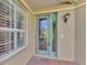 Front door and brick walkway with green door at 4914 Lakescene Pl, Sarasota, FL 34243
