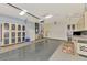 Spacious garage featuring custom cabinetry, a refrigerator, and durable flooring for versatile use at 4914 Lakescene Pl, Sarasota, FL 34243