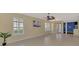 Spacious living room boasts tile flooring, plantation shutters, and neutral wall colors at 4914 Lakescene Pl, Sarasota, FL 34243