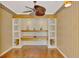 Well-lit office features custom built-ins, hardwood floors, and decorative wallpaper at 4914 Lakescene Pl, Sarasota, FL 34243