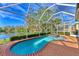 Screened-in pool and spa overlooking lush landscaping and waterfront view at 4914 Lakescene Pl, Sarasota, FL 34243