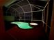 Tranquil screened pool and spa illuminated at night, creating an inviting atmosphere for relaxation and enjoyment at 4914 Lakescene Pl, Sarasota, FL 34243