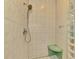 Shower featuring a glass block window, tiled shower with a seat and handheld shower head at 4914 Lakescene Pl, Sarasota, FL 34243