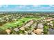 Stunning aerial view of the home with golf course frontage and beautiful landscaping in a desirable community at 7244 Orchid Island Pl, Bradenton, FL 34202