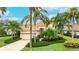 Beautiful home exterior featuring a tile roof, lush landscaping, and a brick driveway at 7244 Orchid Island Pl, Bradenton, FL 34202