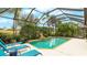 Relaxing screened-in pool area with lounge chairs, complemented by a garden view, perfect for outdoor enjoyment at 7244 Orchid Island Pl, Bradenton, FL 34202