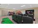 Finished basement with home theater, games, and mini golf at 7416 Riverview Dr, Bradenton, FL 34209