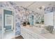 Bathroom with blue wallpaper, white cabinets and large mirror at 7416 Riverview Dr, Bradenton, FL 34209