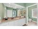 Bathroom with granite vanity, soft green walls, and ample lighting at 7416 Riverview Dr, Bradenton, FL 34209
