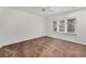 Well-lit bedroom with a large window and neutral walls, ready for personal touches at 7416 Riverview Dr, Bradenton, FL 34209