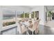 Bright dining room with views of the lake, pool, and outdoor greenery, great for entertaining at 7416 Riverview Dr, Bradenton, FL 34209