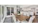 Sunlit dining area with expansive windows and seamless transition to a modern, open kitchen at 7416 Riverview Dr, Bradenton, FL 34209