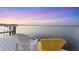 Waterfront view of a tranquil dock with two chairs during sunset at 7416 Riverview Dr, Bradenton, FL 34209