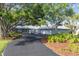Charming single story home featuring mature oak trees, circular driveway, and three-car garage at 7416 Riverview Dr, Bradenton, FL 34209