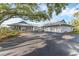 Charming single story home featuring mature oak trees, circular driveway, and three-car garage at 7416 Riverview Dr, Bradenton, FL 34209