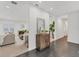 Bright foyer with dark floors, leading to a living room with a fireplace and water views at 7416 Riverview Dr, Bradenton, FL 34209