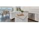 Modern kitchen with white cabinetry, stainless steel appliances, and a view of the waterfront dining area at 7416 Riverview Dr, Bradenton, FL 34209