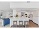 Open-concept kitchen featuring a spacious island with bar seating and modern white cabinetry at 7416 Riverview Dr, Bradenton, FL 34209