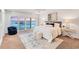 Beautiful bedroom with waterfront views, a plush bed, and access to a private balcony at 7416 Riverview Dr, Bradenton, FL 34209
