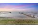 Waterfront property showcases a picturesque view with a grassy lawn and docks at 7416 Riverview Dr, Bradenton, FL 34209