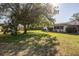 Large, grassy backyard with mature tree, perfect for outdoor activities at 807 62Nd W St, Bradenton, FL 34209