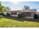 Exterior of home with covered patio and well-maintained lawn at 807 62Nd W St, Bradenton, FL 34209