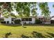 Expansive backyard featuring lush green grass and mature trees providing ample shade at 807 62Nd W St, Bradenton, FL 34209
