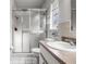 This bathroom features a toilet, vanity, sink, mirror, and a glass shower door at 807 62Nd W St, Bradenton, FL 34209