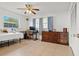 Bedroom with a bed, computer desk, and bureau with tile flooring and natural light at 807 62Nd W St, Bradenton, FL 34209