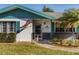 Close-up of the home's entrance with vibrant blue trim and an American flag displayed at 807 62Nd W St, Bradenton, FL 34209