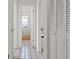 Hallway featuring a bathroom at the end of the hall and multiple storage closets along the right side at 807 62Nd W St, Bradenton, FL 34209