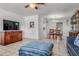 Open-concept living area with tile floors, a TV console, and a view of the dining area at 807 62Nd W St, Bradenton, FL 34209
