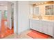 The bathroom features a double vanity with two mirrors and tile backsplash at 8818 29Th E St, Parrish, FL 34219