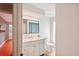 This bathroom features a single vanity with a large mirror and glass block window at 8818 29Th E St, Parrish, FL 34219