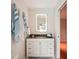This bathroom features an illuminated mirror over a vanity with drawers and cabinets at 8818 29Th E St, Parrish, FL 34219