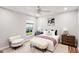 Bright bedroom featuring a plush bed, stylish furniture, and a view of the outdoors at 8818 29Th E St, Parrish, FL 34219