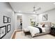 This bedroom features wood floors, gray walls, a ceiling fan, artwork, and a view to the outside at 8818 29Th E St, Parrish, FL 34219
