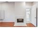Living room with a fireplace with wood flooring and access to other rooms at 8818 29Th E St, Parrish, FL 34219