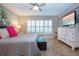Bedroom featuring plantation shutters and neutral colors at 1001 Benjamin Franklin Dr # 110, Sarasota, FL 34236