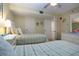 Bedroom with two beds, neutral walls and decor, ceiling fan and beach themed artwork at 1001 Benjamin Franklin Dr # 110, Sarasota, FL 34236