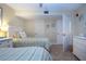 Bedroom with two beds, neutral walls and decor, ceiling fan and beach themed artwork at 1001 Benjamin Franklin Dr # 110, Sarasota, FL 34236