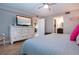 Neutral bedroom with a television, access to an enclosed lanai, and a bathroom at 1001 Benjamin Franklin Dr # 110, Sarasota, FL 34236