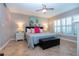 Cozy bedroom featuring neutral walls, tile flooring, and plantation shutters at 1001 Benjamin Franklin Dr # 110, Sarasota, FL 34236