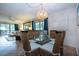 Charming dining area featuring wicker chairs, modern lighting, and an open living space at 1001 Benjamin Franklin Dr # 110, Sarasota, FL 34236