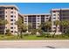 Beautiful condo building with manicured lawn, mature landscaping, and a well-maintained exterior at 1001 Benjamin Franklin Dr # 110, Sarasota, FL 34236