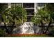Lido Towers sign with tropical landscaping and palm trees in front of a building at 1001 Benjamin Franklin Dr # 110, Sarasota, FL 34236