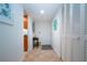Neutral hallway with tile floors and access to rooms at 1001 Benjamin Franklin Dr # 110, Sarasota, FL 34236