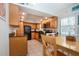 Well-lit kitchen featuring wood cabinetry, tile flooring, and stainless steel appliances at 1001 Benjamin Franklin Dr # 110, Sarasota, FL 34236