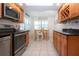 Efficient kitchen with modern appliances, wood cabinets, and a breakfast nook with lots of light at 1001 Benjamin Franklin Dr # 110, Sarasota, FL 34236