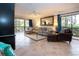 Inviting living room with large windows, tile flooring, cozy seating and elegant decor at 1001 Benjamin Franklin Dr # 110, Sarasota, FL 34236